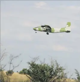  ?? Photo: Contribute­d ?? Airborne… An NDF aircraft flying over Itomba area conducting aerial spraying on African migratory red locust.