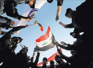  ?? Alaa Al-marjani ?? Reuters Iraqi Federal Police celebrate Sunday in western Mosul, Iraq. Iraqi Prime Minister Haider alabadi congratula­ted the country’s forces on their success in Mosul, but a small area remains under the control of Islamic militants.