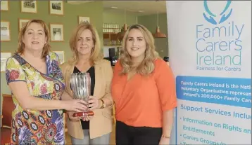 ??  ?? Caroline Poole, Regional Manager, Family Carers Ireland presents the Louth Carer of the Year award to Diane Arthur, with her daughter, Kim.