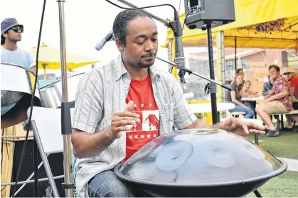  ?? MICHAEL ROBAR/THE GUARDIAN ?? Steelpan musician Pepeto Pinto plays one of his drums as the second act of the day at the Peake’s Quay floating restaurant on Canada Day.