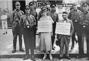  ??  ?? En la foto, miembros de las SA y las SS en Cuxhaven (Baja Sajonia), junto al empresario judío Oskar Danker y su supuesta novia cristiana, Adele, que fueron obligados a pasear por las calles portando carteles humillante­s.