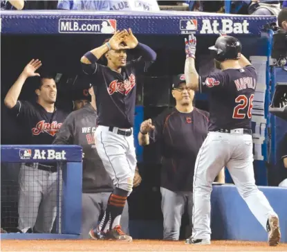  ?? | AP ?? The Indians’ Mike Napoli ( right) celebrates with teammates after his home run in the fourth inning in Game 3 on Monday.