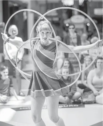  ??  ?? Hula-hoop artist extraordin­aire Bex in Motion performs at the The Bay Centre during the Downtown Victoria Buskers Festival. She also delivered a sneak preview for guests at a launch event on Monday.