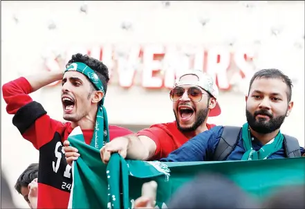  ??  ?? Saudi Arabian soccer fans chant slogans on the eve of the opener of the 2018 soccer World Cup in downtown Moscow, Russia, on June 13. (AP)