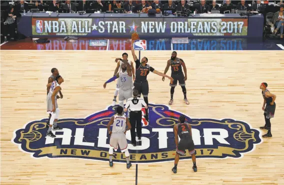  ?? Jonathan Bachman / Getty Images ?? Cleveland’s LeBron James (23, left) and New Orleans’ Anthony Davis go for the opening tip in last season’s All-Star Game, which the West won 192-182.