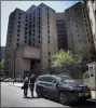  ?? BEBETO MATTHEWS - THE AP ?? New York City medical examiner personnel leave their vehicle and walk to the Manhattan Correction­al Center where financier Jeffrey Epstein died by suicide while awaiting trial on sex-traffickin­g charges, Saturday.