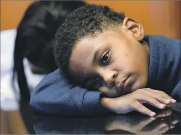  ?? Nam Y. Huh Associated Press ?? JHAIMARION JACKSON, now 10, was 7 when police kicked down the front door of his family’s home in Chicago and ordered him and two siblings to get down on the f loor. They were looking for drug suspects.