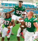  ?? (Reuters) ?? THE SECOND-RANKED Miami Hurricanes avoided their first loss on Saturday, coming back from a two-TD deficit to escape with a 44-28 victory over Virginia. The win kept Miami (10-0, 7-0) undefeated and in the Playoff picture, while extending the nation’s...