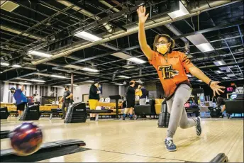  ?? NATHAN BURTON/Taos News ?? Kira Mitchell-Armstrong, 14, throws the ball during Taos High School bowling league practice on Monday (Nov. 22) at Gutters Bowling. Mitchell-Armstrong is one of 19 players in the league separated into four teams. The league, coached by Greg Rael and assistant coach Benny Mitchell, competes in 12 tournament­s throughout the year.