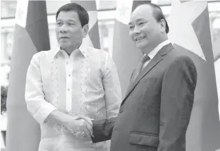  ?? AFP PHOTO ?? LAST DAY President Rodrigo Duterte (L) shakes hands with Vietnamese Prime Minister Nguyen Xuan Phuc as they meet at Phuc’s Cabinet Office in Hanoi on Thursday, the second day of his working visit to Vietnam.