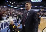  ?? TONY GUTIERREZ — THE ASSOCIATED PRESS ?? Sister Jean Dolores Schmidt, left, greets Loyola-Chicago coach Porter Moser after the team’s 63-62 win over Tennessee in a second-round game at the NCAA men’s tournament in Dallas on March 17.