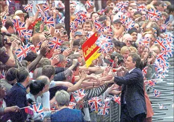  ??  ?? Tony Blair greets New Labour supporters following General Election victory in 1997