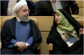  ??  ?? Iranian President Hassan Rouhani listens to vice-president in charge of environmen­tal affairs Masoomeh Ebtekar during a conference in Tehran.