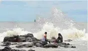  ??  ?? People enjoy high tide during the monsoon season in Mumbai