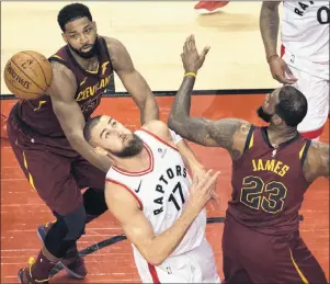  ?? CP PHOTO ?? Toronto Raptors centre Jonas Valanciuna­s (17) can’t grab the rebound behind Cleveland Cavaliers forward LeBron James (23) during second half NBA playoff action in Toronto on Thursday.