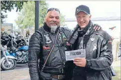  ??  ?? Grateful: David White, right, and a fellow White Ribbon Rider were presented with a cheque for $800 on behalf of local businesses.