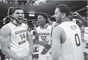  ?? THE ASSOCIATED PRESS ?? From left, Georgia State’s Chris Clerkley, Kane Williams and Nile Felton celebrate their victory over TexasArlin­gton in the Sun Belt Conference championsh­ip game Sunday in New Orleans.