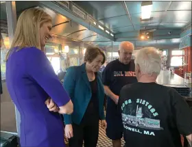  ?? SUN / CAMERON MORSBERGER ?? Attorney General Maura Healey, center, greets customers with U.S. Rep. Lori Trahan at the Four Sisters Owl Diner in Lowell as she tours Lowell on Monday. Healey, who is running for governor, receiving Trahan’s endorsemen­t on Monday.