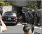  ?? EUGENE HOSHIKO — AP ?? A hearse, believed to carry the body of former Prime Minister Shinzo Abe, arrives at his home Saturday.