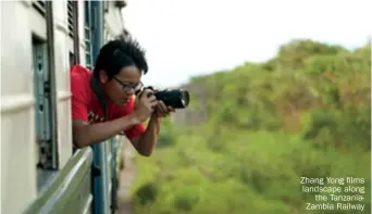  ??  ?? Zhang Yong films landscape along the Tanzaniaza­mbia Railway