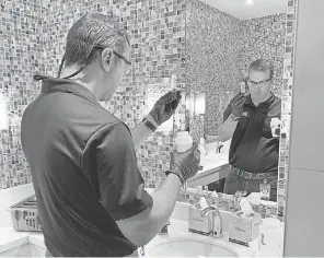  ?? ELIZABETH WEISE/ USA TODAY ?? IWC Innovation­s’ Brian Waymire tests the Ahern Hotel’s water. “Calls have been through the roof” for his staff to help buildings reopen.