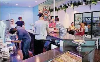  ?? [PHOTO BY DOUG HOKE, THE OKLAHOMAN] ?? Guests filled up tables Friday at Capitals Ice Cream, the latest addition to the former Swanson’s Tire Shop at 1006 N Hudson Ave.