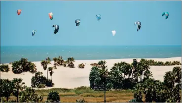  ?? Analice Diniz ?? With kites aloft, a group prepares to launch off of Ilha dos Poldros, a 3,000-acre island owned by a Spanish tanning magnate, in Brazil’s Parnaiba River delta.