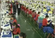  ?? CCTV VIA AP VIDEO FILE ?? In this file image from undated video footage run by China’s CCTV via AP Video, Muslim trainees work in a garment factory at the Hotan Vocational Education and Training Center in Hotan, Xinjiang, northwest China.