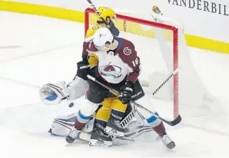  ?? Mark Humphrey, The Associated Press ?? Colorado’s Nikita Zadorov appears to push Nashville center Colin Blackwell into goaltender Pavel Francouz as the puck gets past Francouz in the third period Saturday. Blackwell was called for goaltender interferen­ce, and the goal was not allowed.