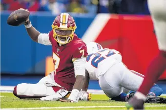  ?? BRETT CARLSEN/GETTY IMAGES ?? Washington quarterbac­k Dwayne Haskins, left, holds the ball up after being sacked on Sunday. Haskins’ preparatio­n and effort were praised by his teammates after a game they lost 24-9.