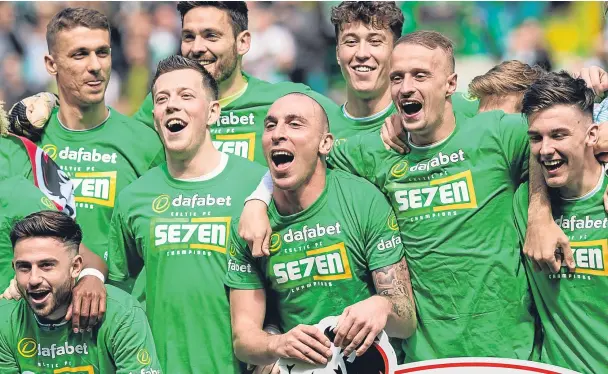  ??  ?? CHAMPION SHOW: Captain Scott Brown, centre, leads the Celtic celebratio­ns at the end of yesterday’s match