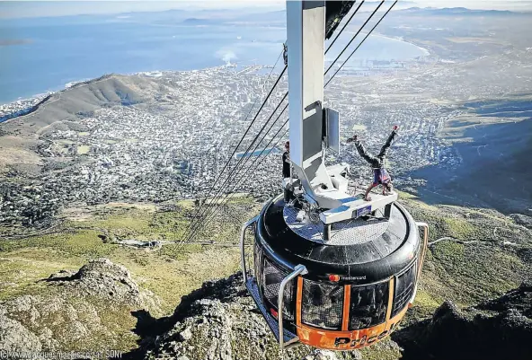  ?? Picture: Jacques Marais ?? STEADY HANDS One of Ayliffe’s most spectacula­r handstands was on top of the Table Mountain cable car, with Cape Town stretched out below.