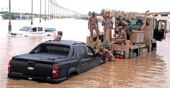  ??  ?? Army personnel recovering submerged vehicles in Dhofar Governorat­e.