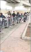  ?? Associated Press ?? In this 2019 file photo, asylum seekers in Tijuana, Mexico, listen to names being called from a waiting list to claim asylum at a border crossing in San Diego.