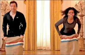  ??  ?? Potato sack: Michelle Obama flexed her muscles against Jimmy Fallon during a fitness competitio­n in the White House