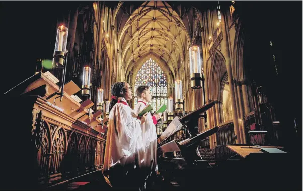  ?? PICTURE: JAMES HARDISTY ?? COMFORT AND JOY: Choristers Naomi Simon, 13, and Oliver Musgrave, 12, prepare for the Christmas services at York Minster.