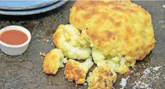  ?? [MELISSA D’ARABIAN VIA AP] ?? Cheesy pull-apart whole roasted cauliflowe­r.