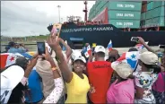  ?? AP ?? A woman takes a selfie as the Neopanamax cargo ship, part of COSCO Shipping Panama, crosses the new Agua Clara locks.