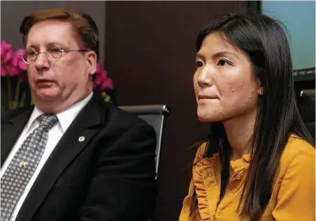  ?? Melissa Phillip / Houston Chronicle ?? Tu Thien Huynh joins her attorney, David Armbruster, at a news conference Wednesday. She was charged with murder in the death of her husband, Steven Hafer, but the charges have been dropped and her husband’s death has been ruled a suicide.