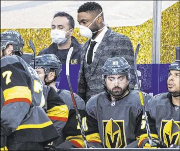  ?? Chase Stevens Las Vegas Review-Journal @csstevensp­hoto ?? Joel Ward, center, and the AHL Silver Knights’ staff helped behind the Golden Knights’ bench on Jan. 26 against the St. Louis Blues.