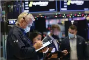  ?? COLIN ZIEMER — NEW YORK STOCK EXCHANGE ?? Traders work on the floor on Monday.