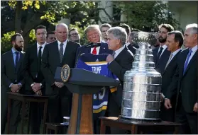  ?? EVAN VUCCI — THE ASSOCIATED PRESS ?? President Donald Trump is presented a team jersey by Blues owner Tom Stillman during an event to honor the 2019 Stanley Cup Champion St. Louis Blues in the Rose Garden of the White House on Tuesday.