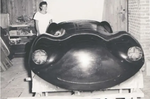  ??  ?? Dick Frew with the completed fibreglass body for the sports car he built in his parents’ Kerrisdale basement in the mid-1950s.