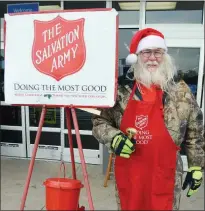  ?? TAMMY KEITH/RIVER VALLEY & OZARK EDITION ?? Gerald Finnegan of Conway stands by The Salvation Army Red Kettle at the Walmart Supercente­r on Harkrider Street in Conway, where he rings a bell five days a week. Finnegan, 64, said he volunteers to give back because The Salvation Army helped him when he needed it. “I love the kids,” he said. More volunteers are needed to man the kettles, The Salvation Army Conway Corps officers said.