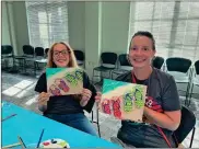  ?? Contribute­d ?? The Summer Reading has a wide variety of events for teens and adults too. This happy pair took a canvas painting class at our Chickamaug­a branch last summer.