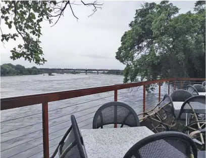 ?? Picture: SANParks. ?? INUNDATED. The Sabie River rushes past the Skukuza restaurant on Thursday.