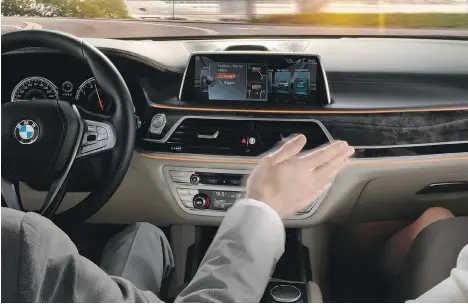  ??  ?? Gesture Control, a new feature in the BMW 7 Series, allows the driver to perform various in-car functions with a simple wave of the hand.