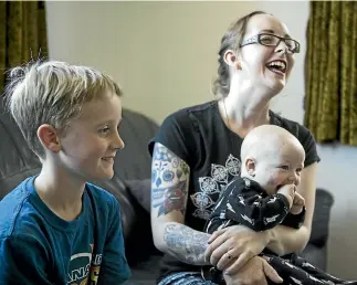  ?? GEORGE HEARD/STUFF ?? Christchur­ch mother Kirsty Wilkinson says tongue-tie surgery was ‘‘traumatic and heartbreak­ing’’ for her two older sons, including Connor, 9, left, so she decided against it for baby Leith.