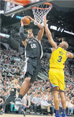  ?? AP ?? The Spurs’ LaMarcus Aldridge, left, shoots against the Warriors’ David West.