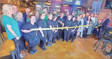  ?? Jeremy stewart ?? The Rails at Rockmart owner Bill Sportiello (center) cuts the ribbon officially opening the bar and grill at 108 E. Church St. in Rockmart during a ceremony Thursday, March 17. Sportiello said they are hoping to bring a high grade of food, drinks and service to the community.